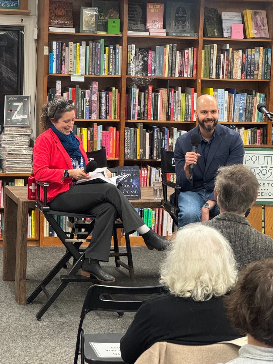 Dagomar Degroot speaking with a guest at a public event